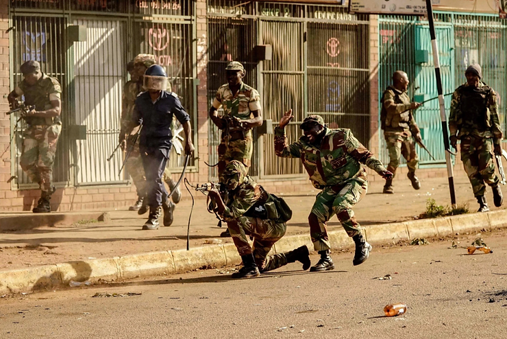 A soldier trained his weapon during the 2018 election protests. Zinyange Auntony/Agence France-Presse — Getty Images